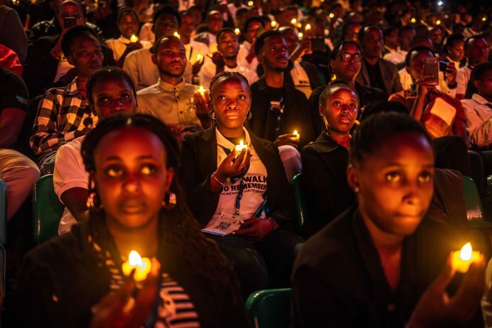 Young Rwandans hold flameless candles while taking part in a vigil during the commemorations of the 30th Anniversary of the 1994 Rwandan genocide at the BK Arena in Kigali on Sunday. - AFP