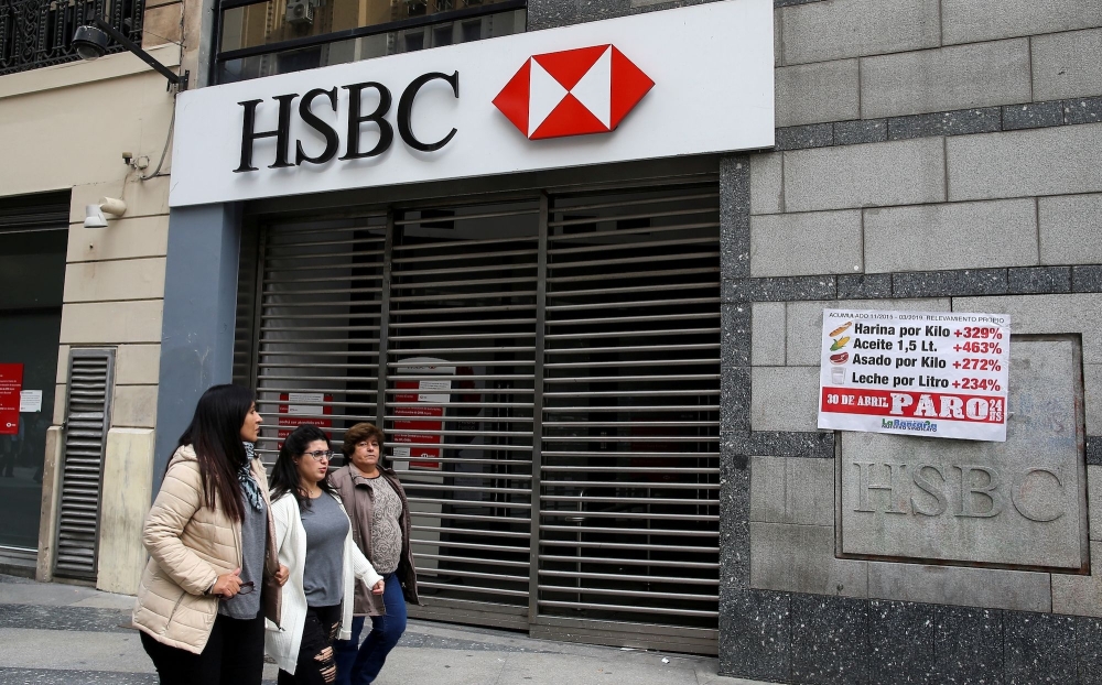  Pedestrians walk past a closed HSBC branch in Buenos Aires, Argentina. — Reuters