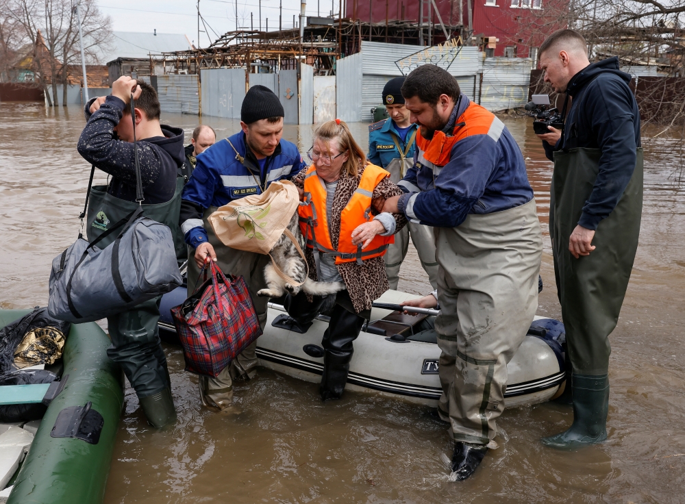 Local resident Taisia is evacuated amid flooding in the city of Orenburg, Russia. - Reuters