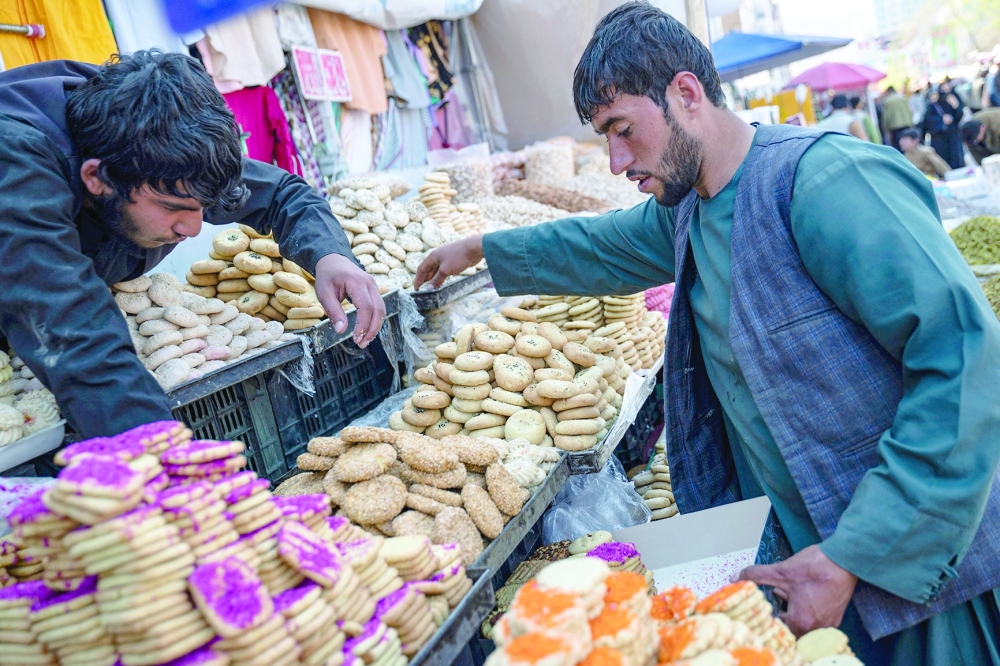 Afghan vendors waiting for customers prepare local cookies called "kulcha" ahead of Eid al-Fitr, which marks the end of the Muslim holy fasting month of Ramadan at a market in Kabul on April 7, 2024.