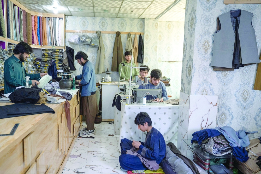 Afghan tailors sew clothes ahead of Eid al-Fitr, which marks the end of the Muslim holy fasting month of Ramadan at a workshop in Kabul on April 7, 2024.