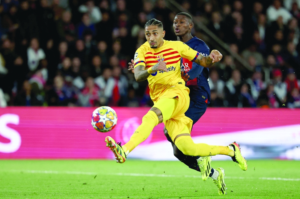 Raphinha volleys the ball to score Barcelona's second goal during the UEFA Champions League quarter final first leg football match between PSG and Barcelona at the Parc des Princes stadium in Paris on April 10, 2024.