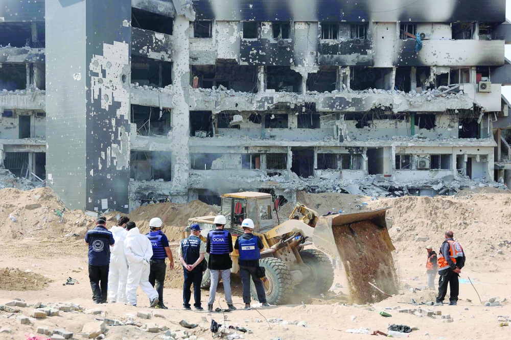 A United Nations (UN) team visit as Palestinian civil defence recover human remains the grounds of Al Shifa Hospital, Gaza's largest hospital, which was reduced to ruins by a two-week Israeli raid, amid the ongoing conflict between Israel and the Palestinian Hamas militant group. - AFP