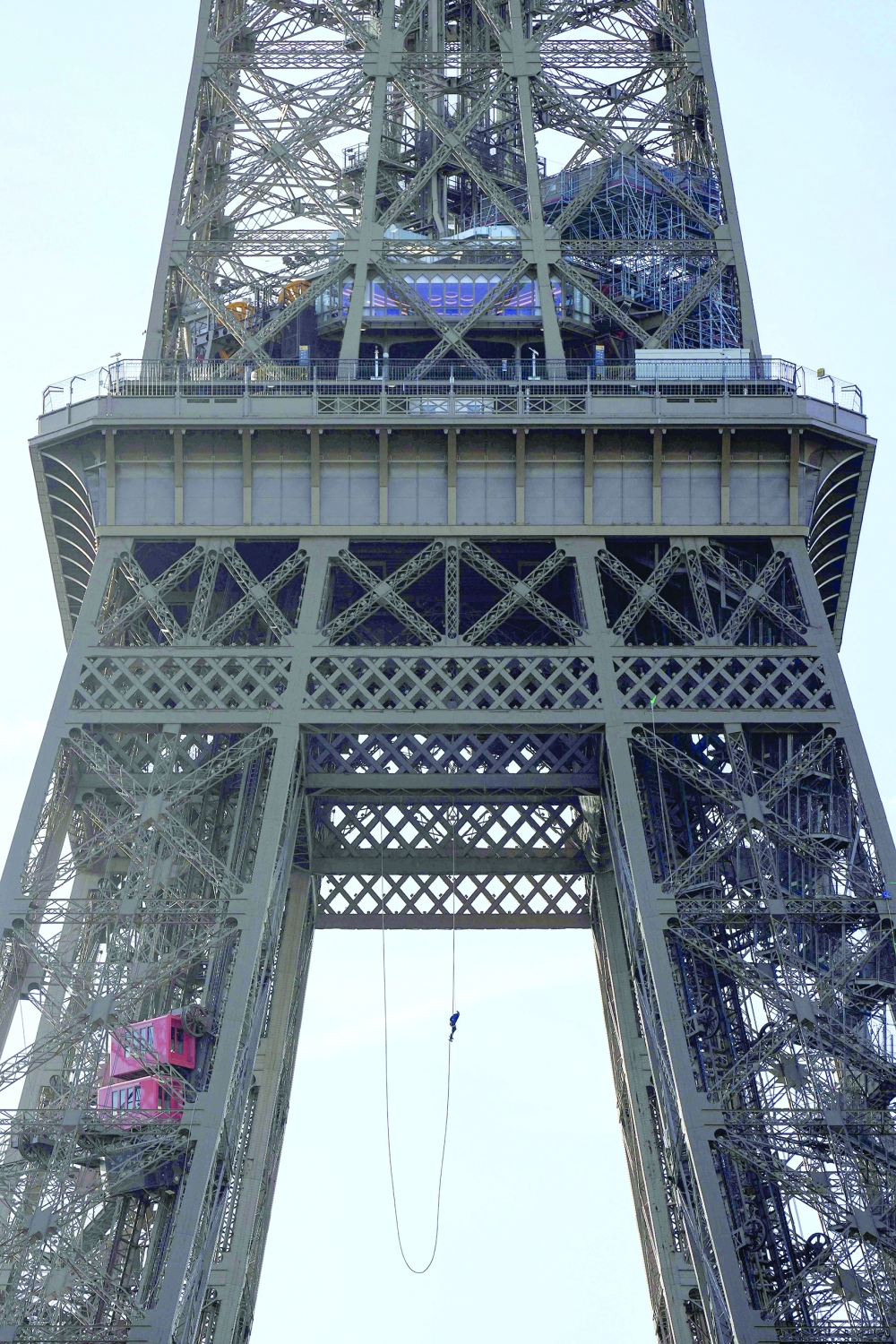 Anouk Garnier climbs up the Eiffel Tower. — AFP