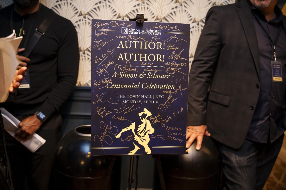 Authors signatures on a placard in the waiting room for those waiting to appear onstage at a centennial celebration for publisher Simon & Schuster at The Town Hall in Manhattan, on April 8, 2024. — NYT 