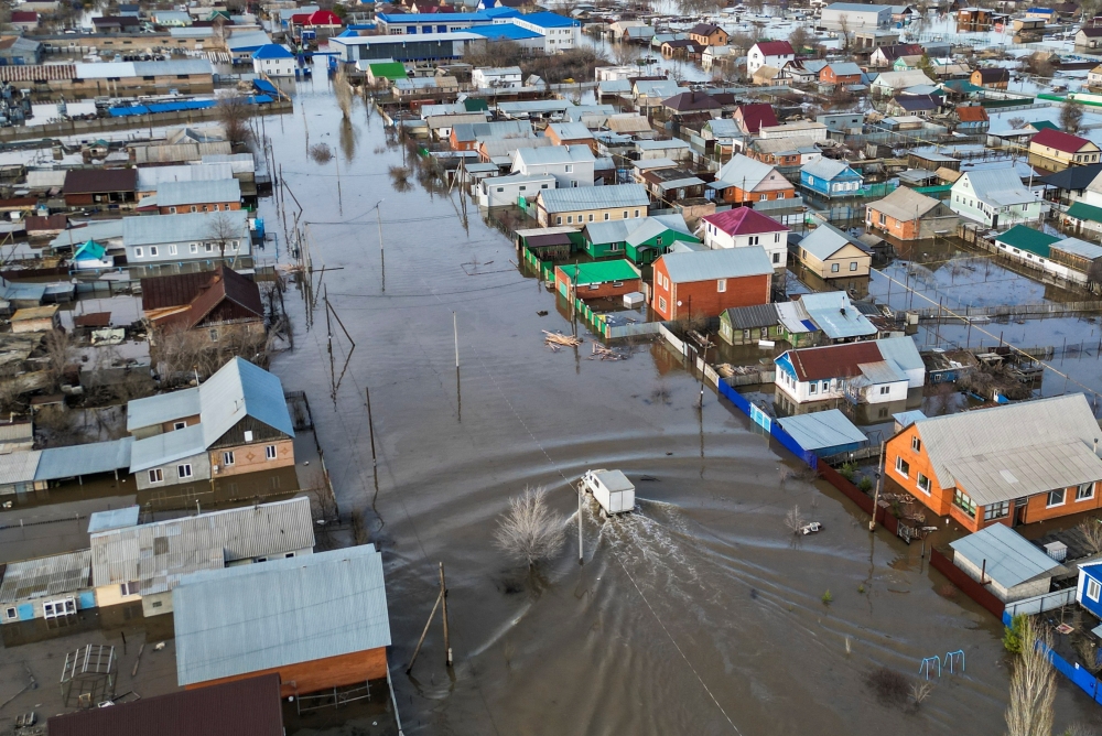 A drone view shows a truck driving along the flooded street in the settlement of Zarechnoye, Orenburg region, Russia, on Friday. - Reuters