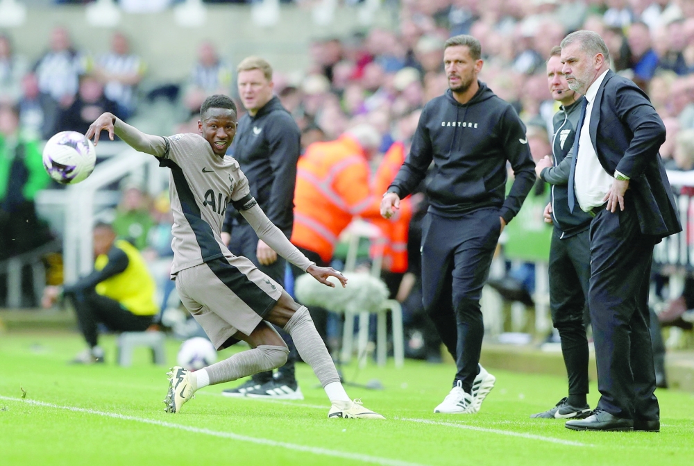 Tottenham Hotspur's Pape Matar Sarr in action as Tottenham Hotspur manager Ange Postecoglou, Newcastle United manager Eddie Howe and assistant manager Jason Tindall look on -- REUTERS