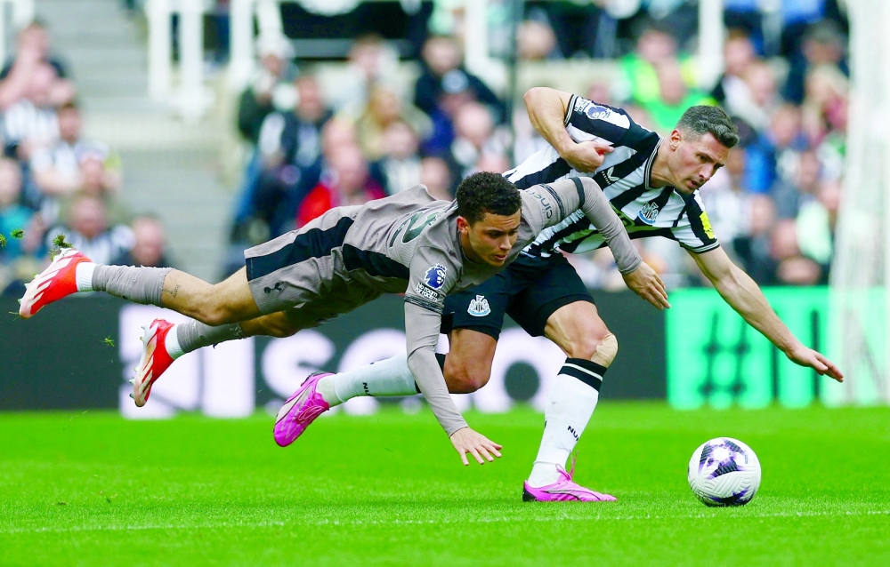 Newcastle United's Fabian Schar in action with Tottenham Hotspur's Brennan Johnson -- Reuters