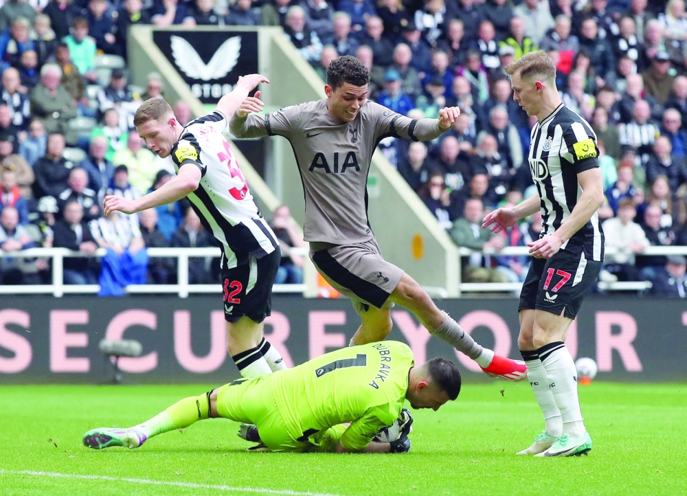 Newcastle United's Martin Dubravka in action with Tottenham Hotspur's Brennan Johnson -- REUTERS