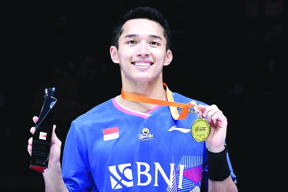 Indonesia Jonatan Christie poses on the podium after winning the men's singles final match  -- AFP