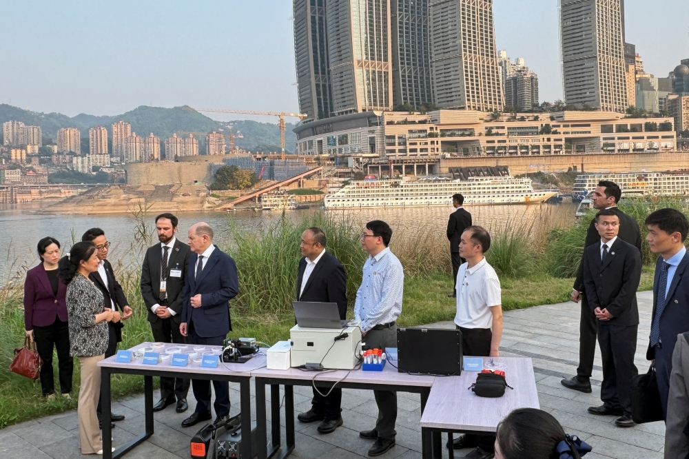 German Chancellor Olaf Scholz visits a research project on the monitoring of water quality in Chongqing, China. — Reuters 