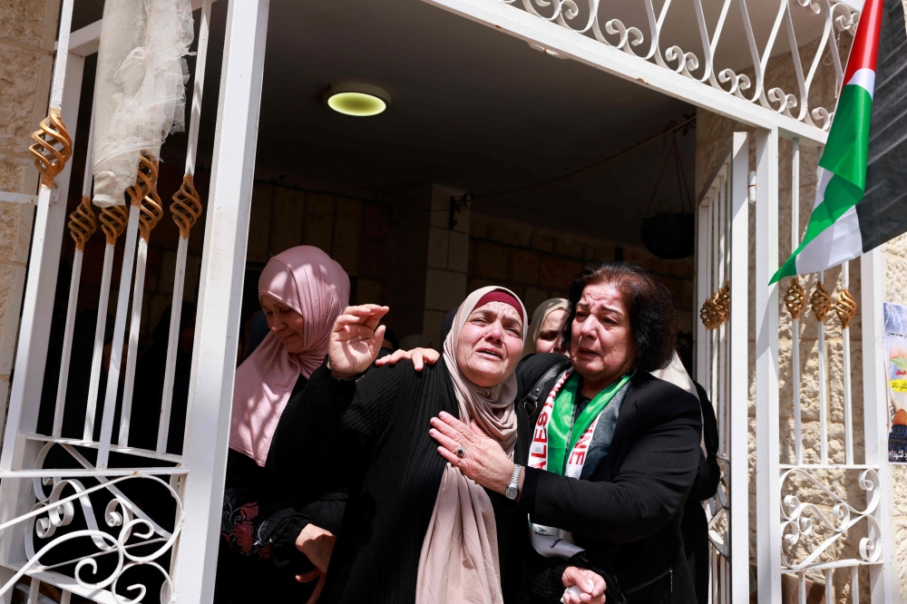 Relatives mourn during the funeral of Omar Hamed, who was killed during clashes with Israeli settlers, Ramallah. — AFP 