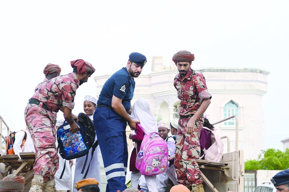 Students being rescued from a bus stuck in flood waters.