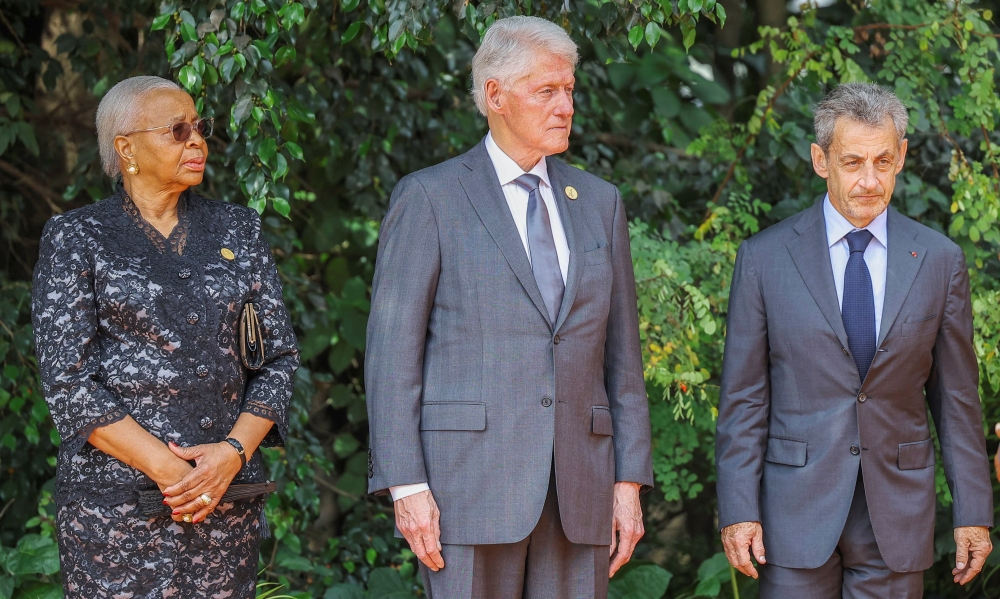 Former US president Bill Clinton, Graca Machel, widow of former South African President Nelson Mandela, and Former French president Nicolas Sarkozy pay homage before lighting the Rwandan genocide flame of hope. - Reuters