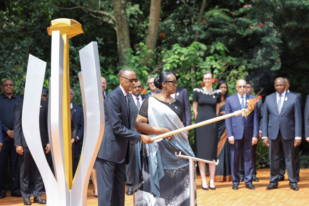 Rwandan President Paul Kagame and First Lady Jeanette Kagame prepare to light the Rwandan genocide flame of hope, known as the 'Kwibuka' (Remembering), to commemorate the 1994 Genocide at the Kigali Genocide Memorial Center in Kigali, Rwanda, on April 7. - Reuters
