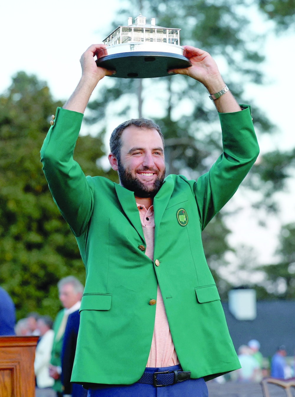 Scottie Scheffler of the US celebrates with his green jacket and the trophy after winning The Masters.