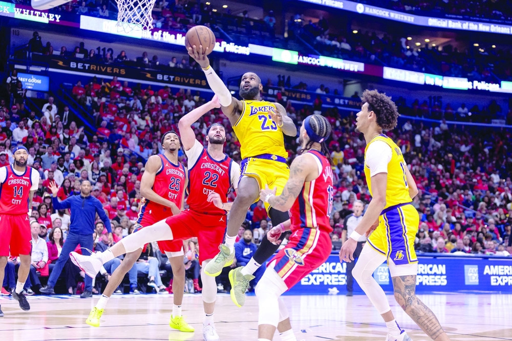 Los Angeles Lakers forward LeBron James (23) shoots against New Orleans Pelicans forward Larry Nance Jr. (22) during the second half of a play-in game of the 2024 NBA playoffs at Smoothie King Center. 
