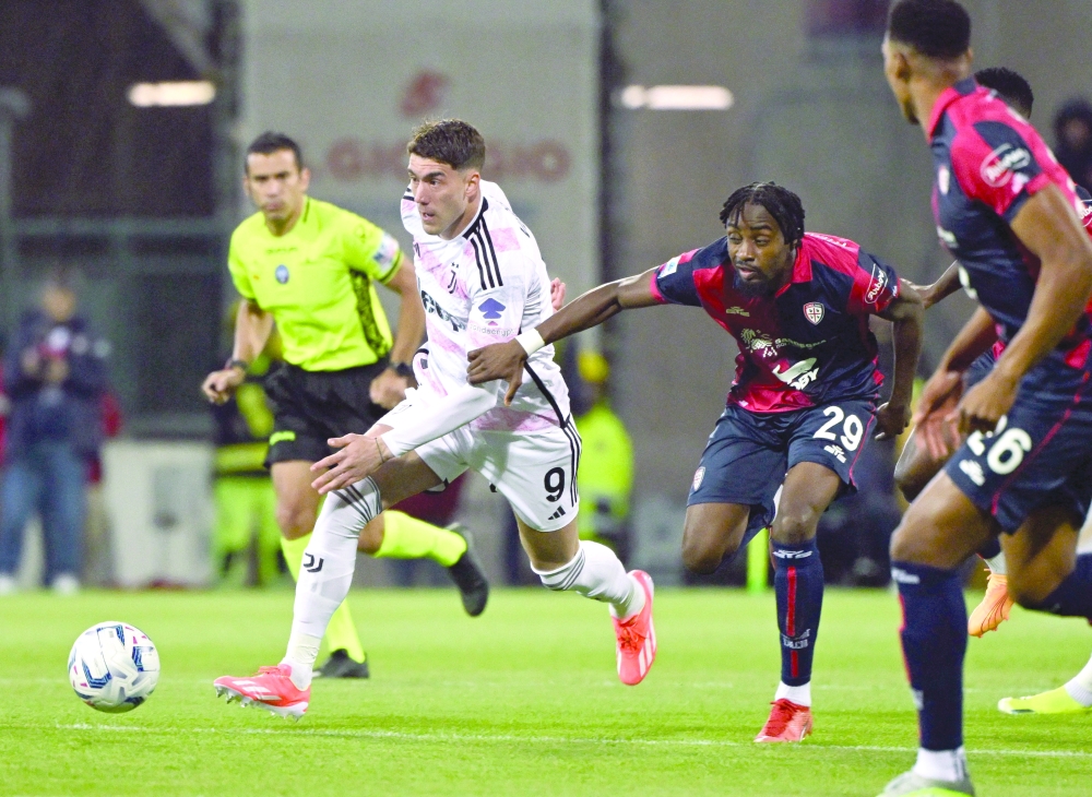 Juventus' Dusan Vlahovic in action with Cagliari's Antoine Makoumbou -- REUTERS