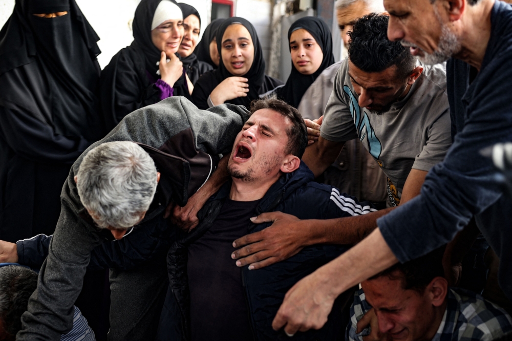  A Palestinian man mourns relatives killed in Israeli bombing in Rafah in the southern Gaza Strip. — AFP 