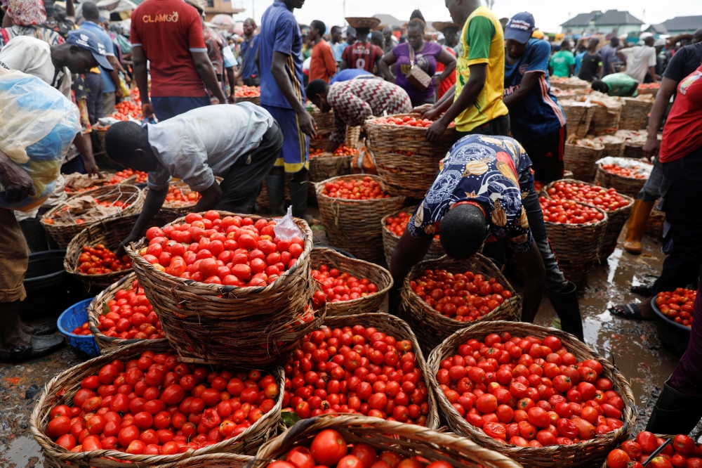 People buy and sell vegetables at Mile 12 International Market in Lagos, Nigeria. — Reuters