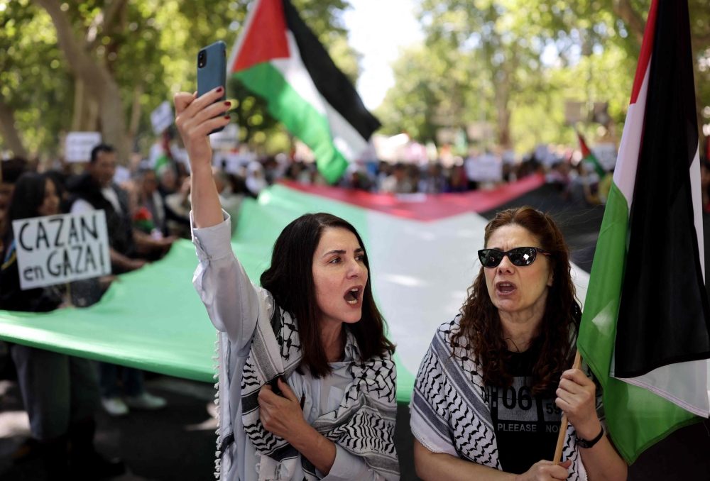 People rally in support of the people from the Gaza Strip, in the Palestinian territories, in Madrid. — AFP 