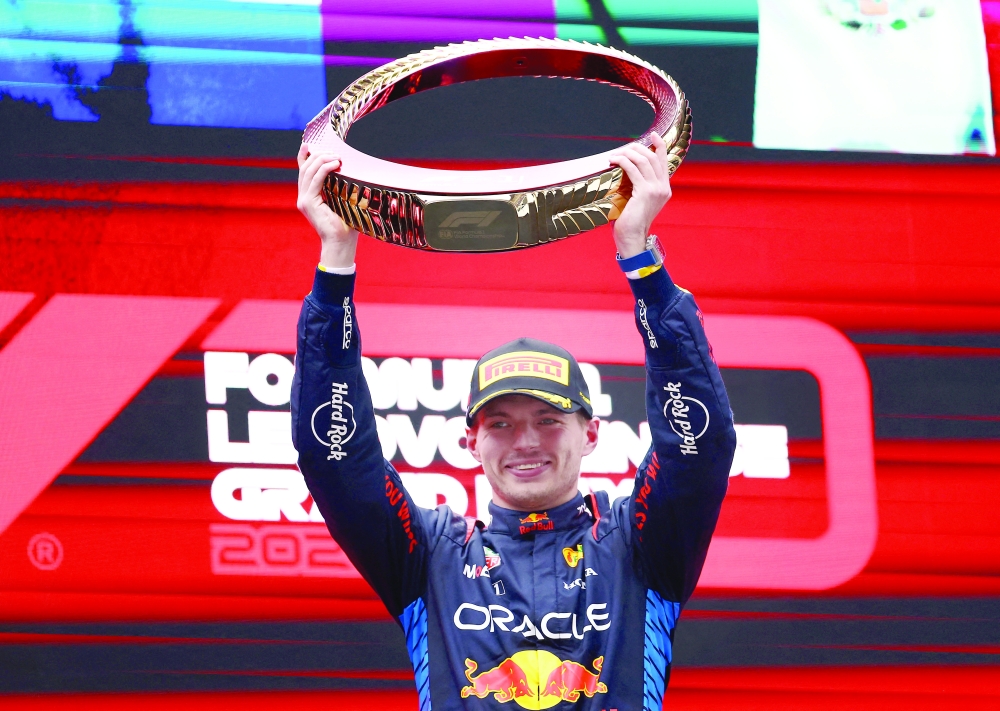 Formula One F1 - Chinese Grand Prix - Shanghai International Circuit, Shanghai, China - April 21, 2024 Red Bull's Max Verstappen celebrates with the trophy on the podium after winning the Chinese Grand Prix. REUTERS