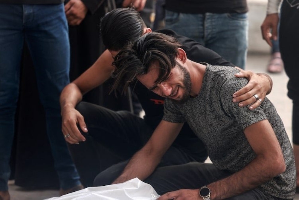 Palestinians mourn by the bodies of relatives killed in Israeli bombardment, at the al-Najjar hospital in Rafah in Thursday.
