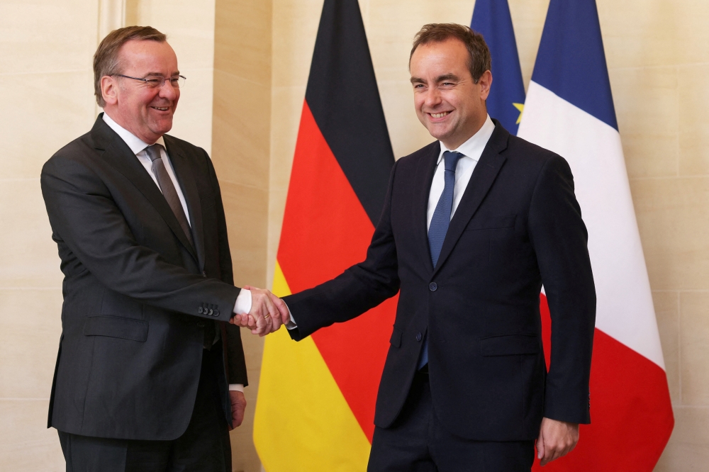 French Defence Minister Sebastien Lecornu shakes hands with his German counterpart Boris Pistorius as they meet at the Hotel de Brienne in Paris on Friday