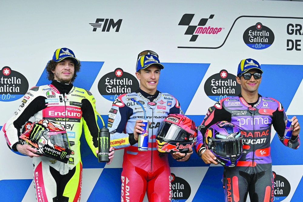 (From L) Ducati Italian rider Marco Bezzecchi, Ducati Spanish rider Marc Marquez and Ducati Spanish rider Jorge Martin pose for pictures after the qualifier session of the MotoGP Spanish Grand Prix -- AFP