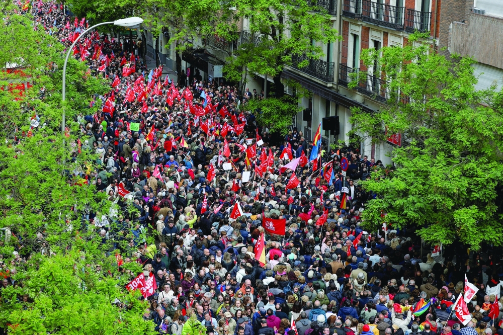 People gather outside Spain's Socialist Party (PSOE) headquarters to show support for Prime Minister Pedro Sanchez, in Madrid. — Reuters 