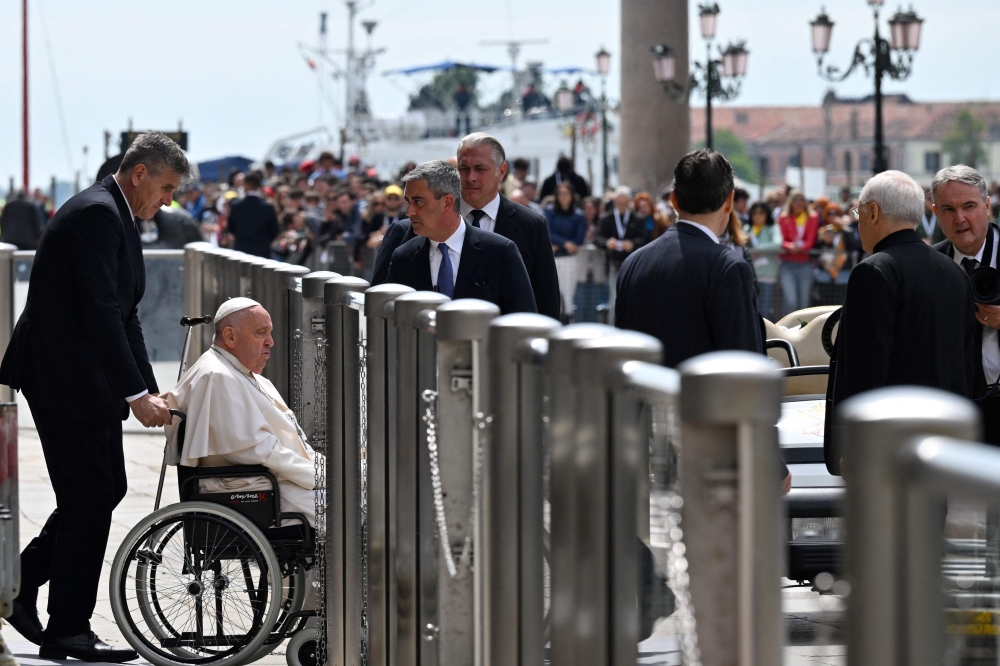 Pope Francis leaves St. Marks basilica at the end of his visit in Venice. — AFP 