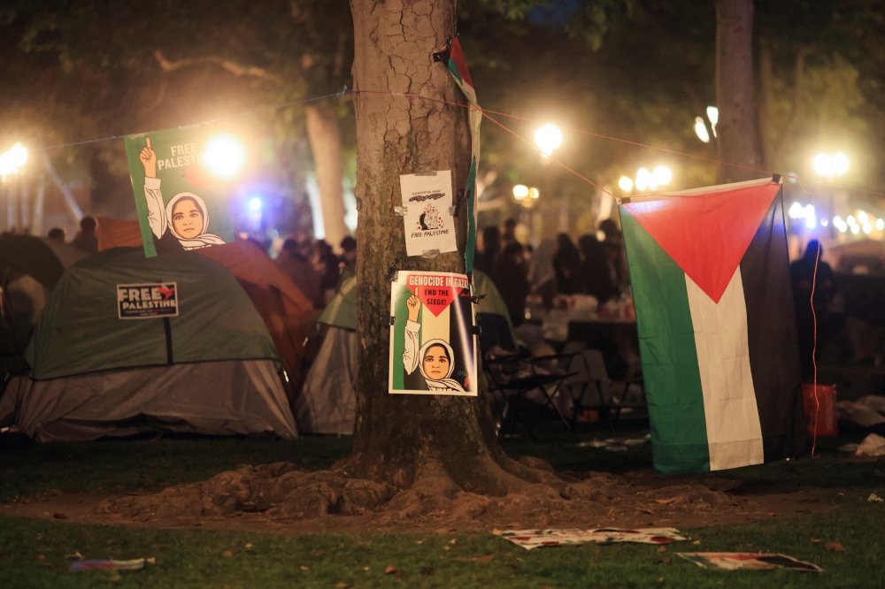 A Palestinian flag and posters are put up as people protest in support of Palestinians at the University of Southern California (USC), in Los Angeles. — Reuters 
