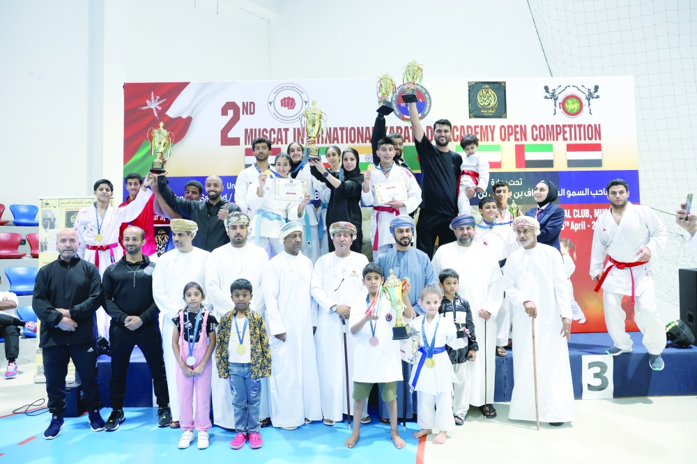 The winners and officials pose at Al Amal Club.