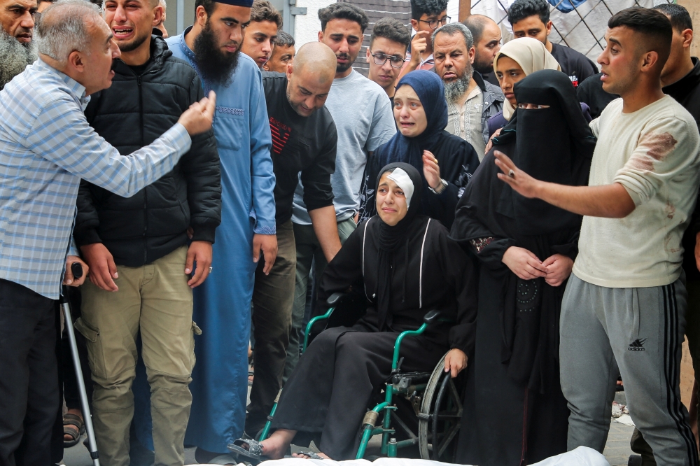 Mourners react during the funeral of Palestinians killed in Israeli strikes, in Rafah. — Reuters 