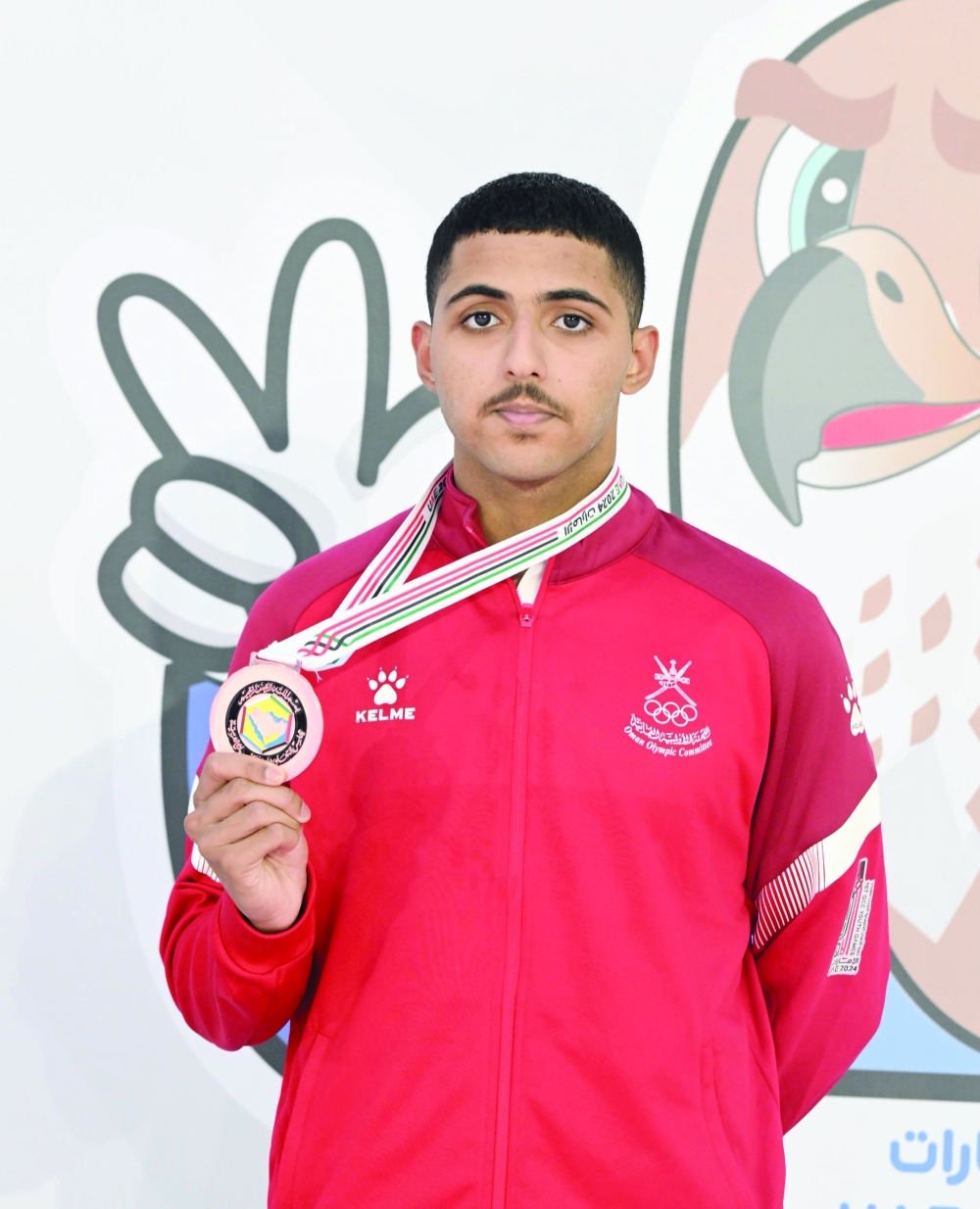 Swimmer Hilal Suleiman al Mashari with his bronze medal.