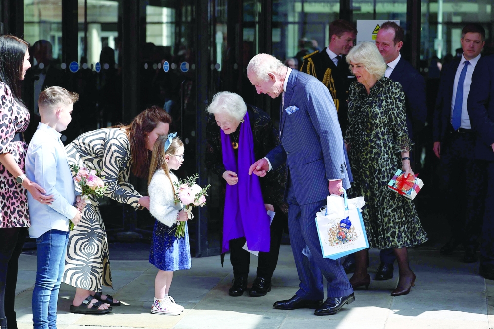 Britain's King Charles III and Britain's Queen Camilla recieve a bouquet of flowers after a visit to the University College Hospital Macmillan Cancer Centre in London. — AFP 