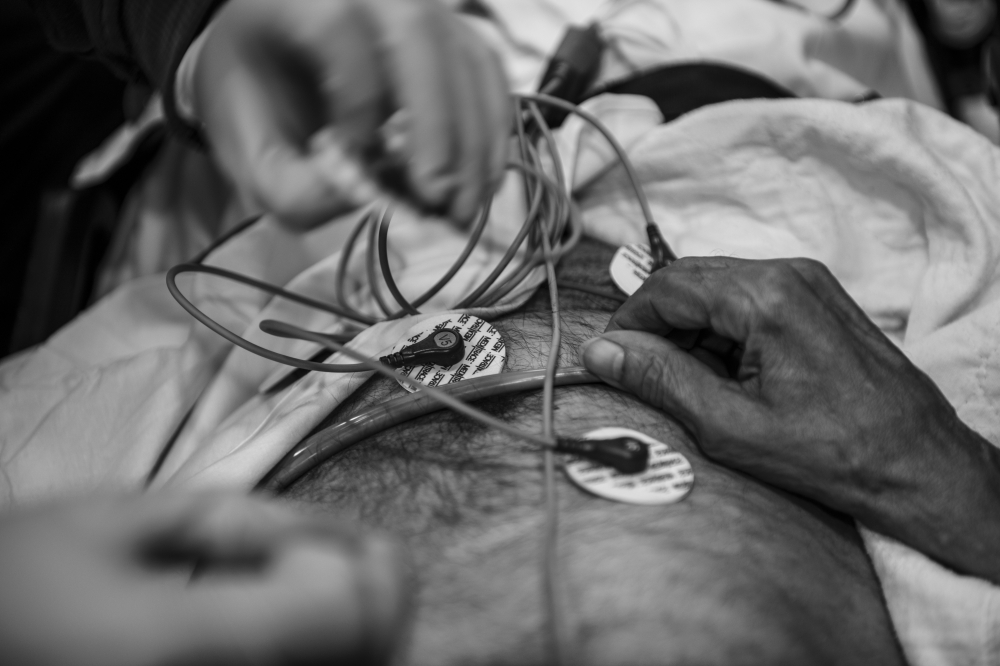 A paramedic applies an electrocardiogramto a patient in an ambulance in Yonkers, N.Y., on April 18, 2020. (Andrew Renneisen/The New York Times)