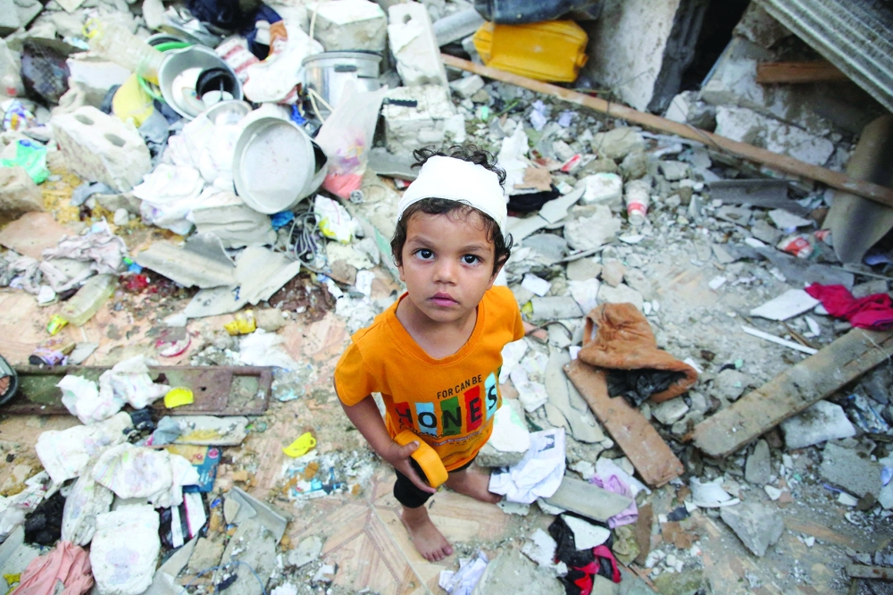 A wounded Palestinian boy at the site of an Israeli strike on a house in Rafah on Wednesday. — Reuters