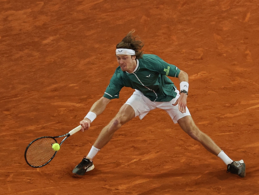 Russia's Andrey Rublev returns the ball to Spain's Carlos Alcaraz during the 2024 ATP Tour Madrid Open tournament quarter-final tennis match at Caja Magica in Madrid on May 1, 2024. (Photo by PIERRE-PHILIPPE MARCOU / AFP)