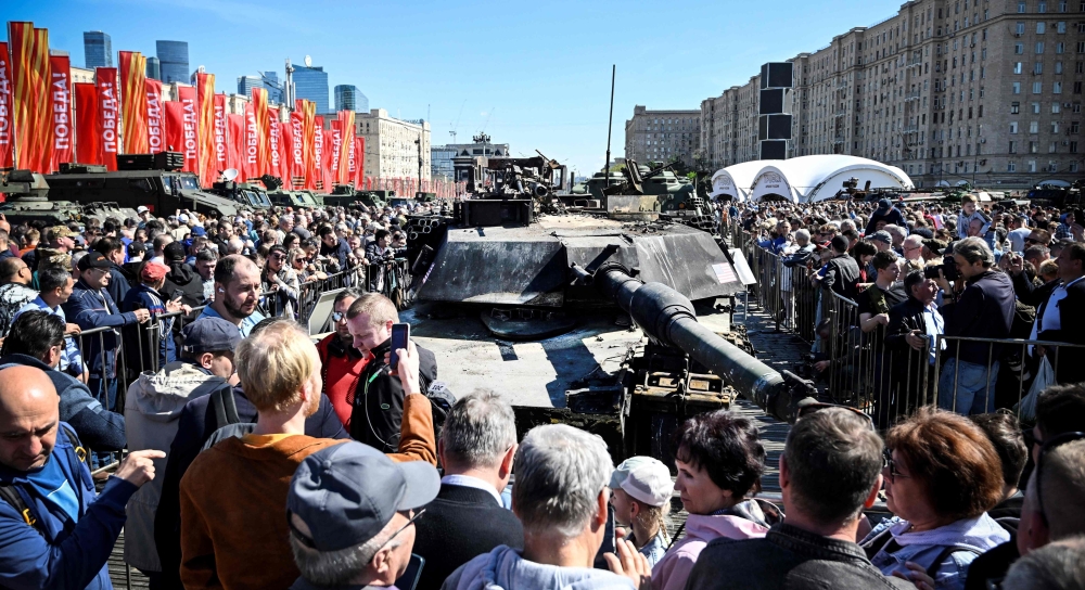 People look at US M12A1 Abrams tank captured by Russian forces in Ukraine, displayed at the WWII memorial complex at Poklonnya Hill western