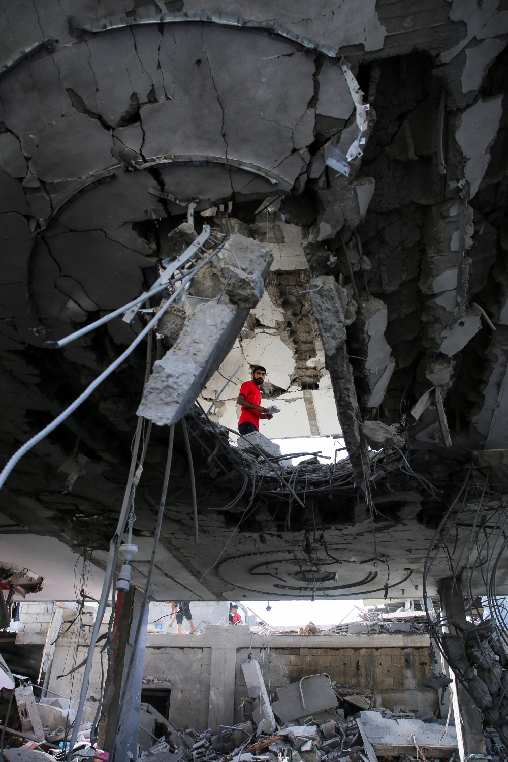 A person stands inside a building, damaged in an Israeli strike, in Rafah on Friday. — Reuters