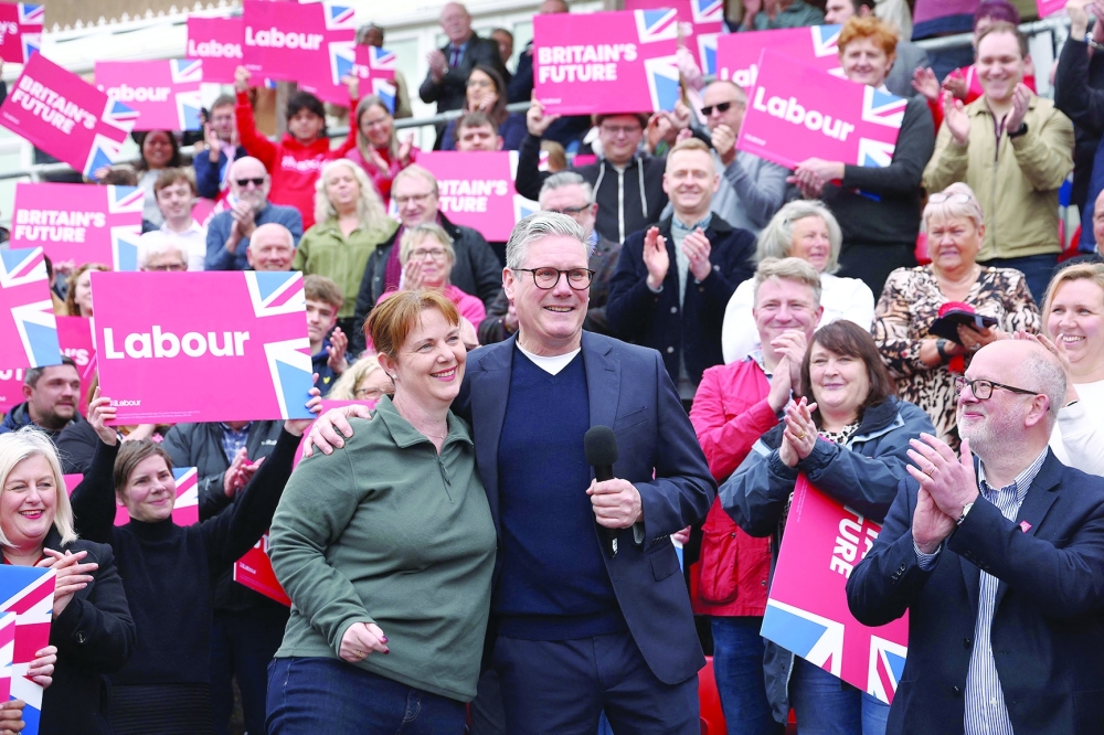 Britain's main opposition Labour Party leader Keir Starmer embraces new East Midlands Mayor Claire Ward during a post local election rally in Mansfield, central England. — AFP 