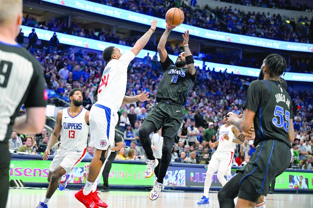 Kyrie Irving (11) shoots the ball over Norman Powell (24). — USA TODAY Sports