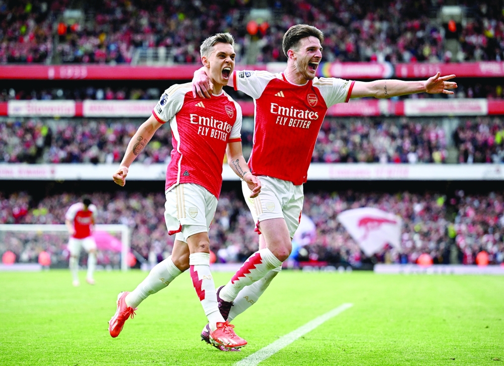 Arsenal's Leandro Trossard celebrates scoring their second goal with Declan Rice.— REUTERS
