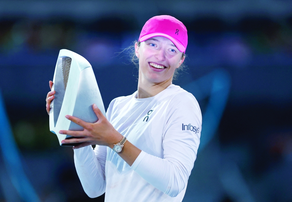 Poland's Iga Swiatek celebrates with the trophy.—  REUTERS