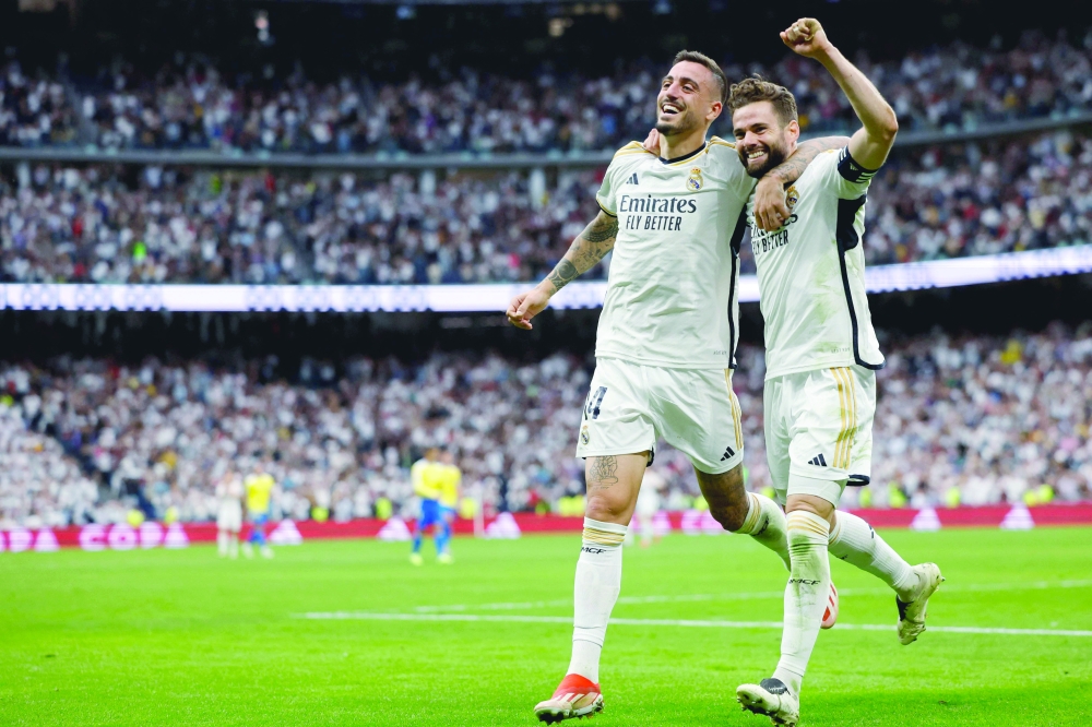 Joselu (L) celebrates scoring his team's third goal, with Nacho Fernandez. — AFP

