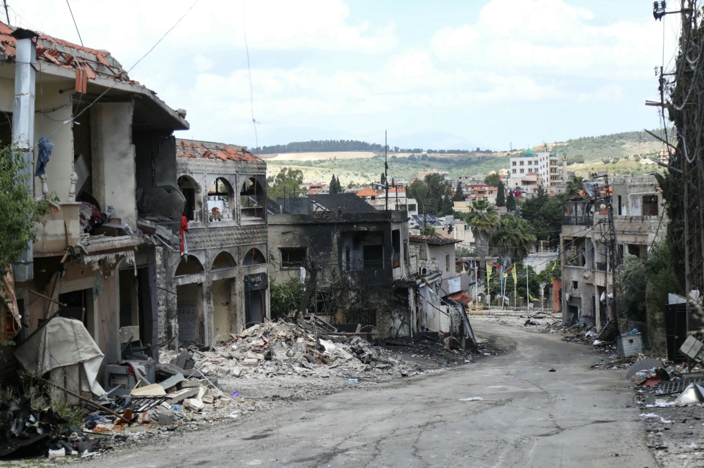 Debris are scattered around buildings damaged by an Israeli strike in the southern Lebanese border village of Mays al-Jabal. — AFP 