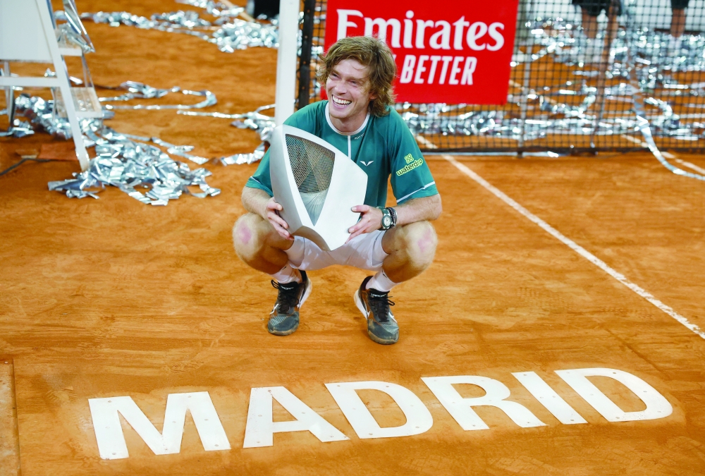 Russia's Andrey Rublev poses with the trophy after winning his final match against Canada's Felix Auger Aliassime. - REUTERS