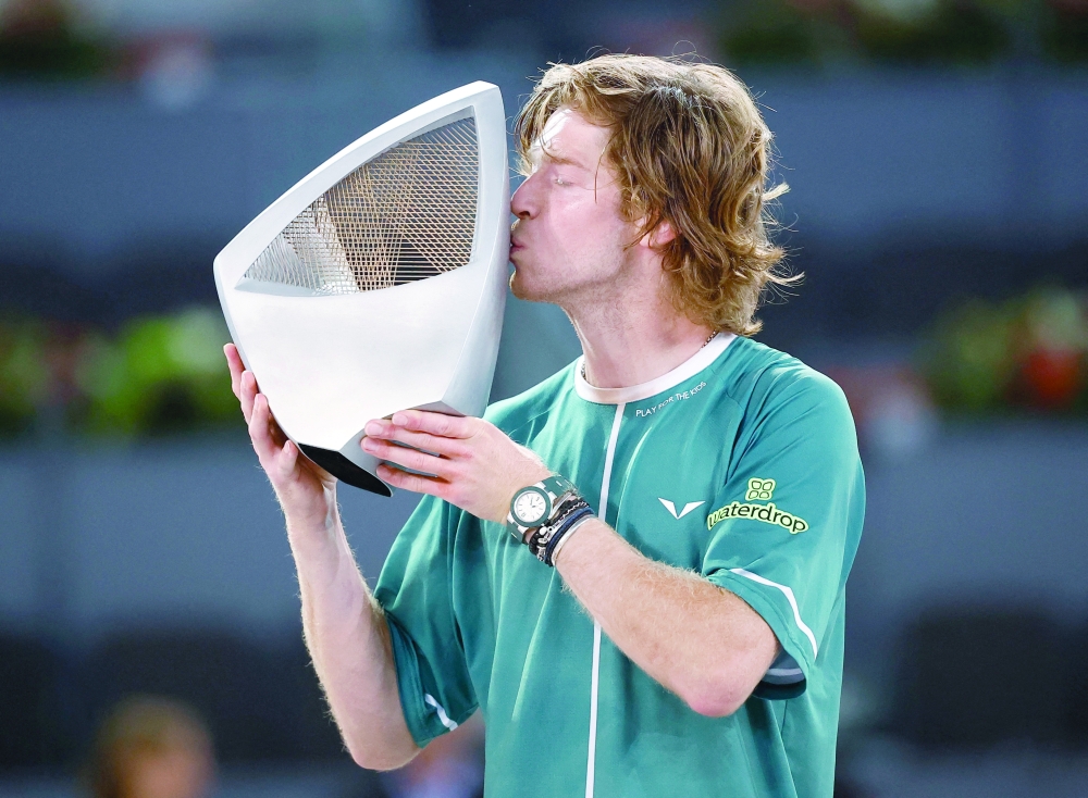 Russia's Andrey Rublev celebrates with the trophy after winning his final match against Canada's Felix Auger Aliassime. - REUTERS