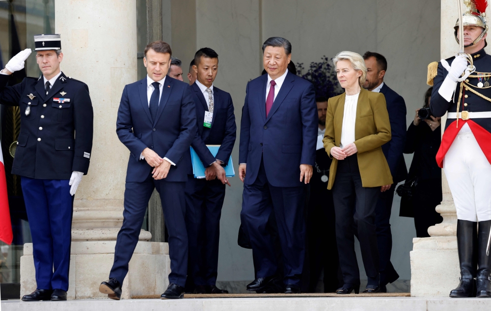 (From L) France's President Emmanuel Macron, Chinese President Xi Jinping and European Commission President Ursula von der Leyen leave after holding a trilateral meeting, at the Elysee Palace in Paris. — AFP